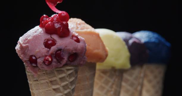 istock Row of multi-colored icecream cones on black background. Close-up 1270919119