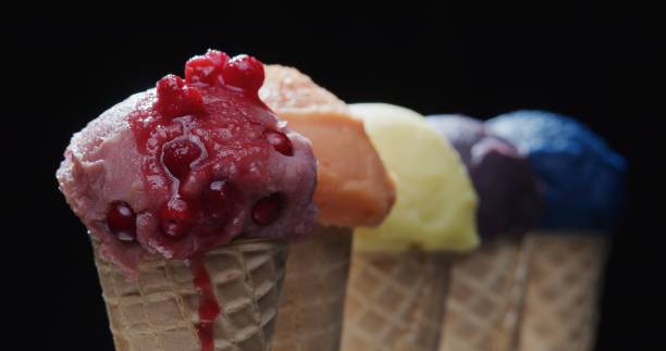 istock Row of multi-colored icecream cones on black background. Close-up 1270919123