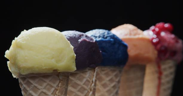 istock Row of multi-colored icecream cones on black background. Close-up 1270919134
