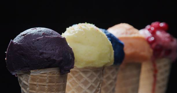istock Row of multi-colored icecream cones on black background. Close-up 1270919164