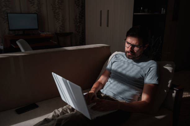 istock Remote Job. Man Working On Laptop Sitting On Sofa At Home 1270921615