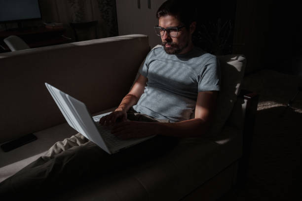 istock Remote Job. Man Working On Laptop Sitting On Sofa At Home 1270923374