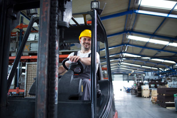 istock Shot of professional operator forklift driver. Worker operating forklift in industrial workshop. 1270923513