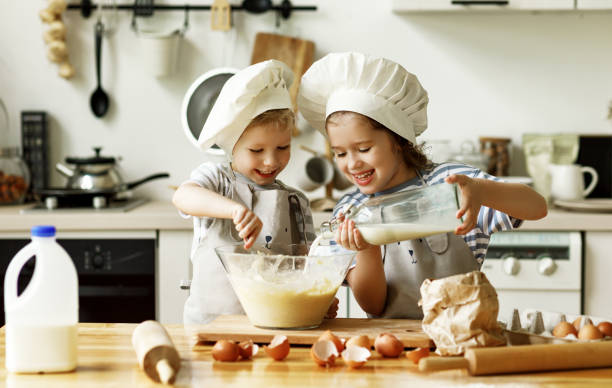 istock Happy siblings preparing food in kitchen 1270924310