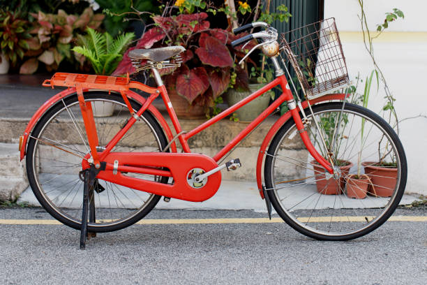 istock Red Vintage Bicycle Parked On Street By Building 1270926054