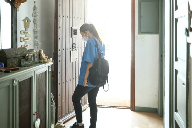 istock Woman with Backpack Leaving Home in Protective Face Mask 1270929341
