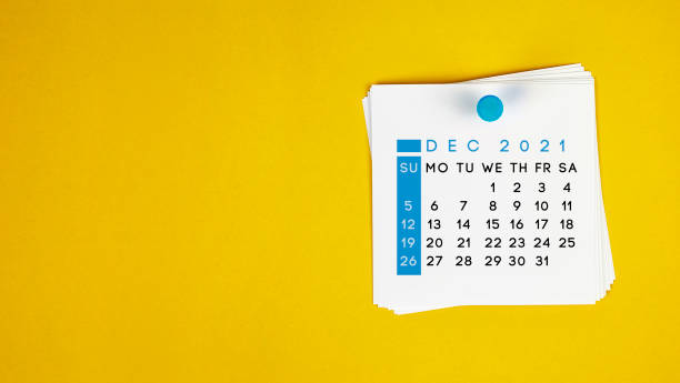 The December 2021 calendar is pinned on a yellow background. The December 2021 calendar is pinned on a yellow background. Horizontal composition with copy space. december stock pictures, royalty-free photos & images