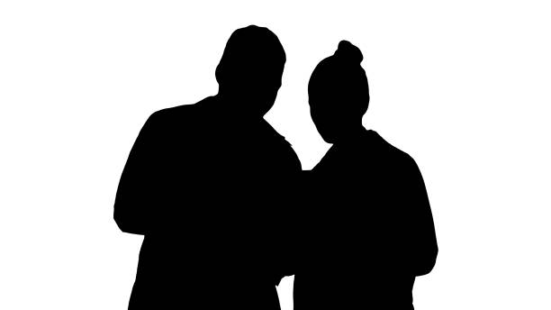 Silhouette Medical staff working in front of a grey laptop while standing