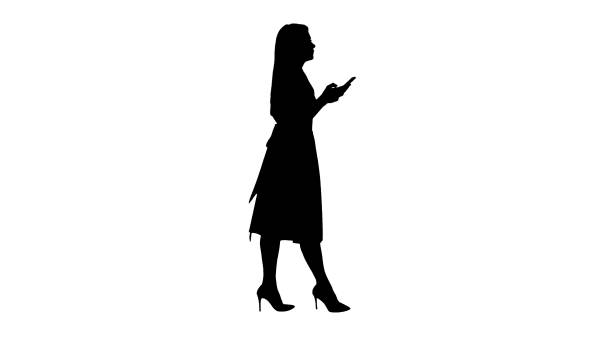 istock Silhouette Pretty blonde woman using cell phone texting message 1270929777