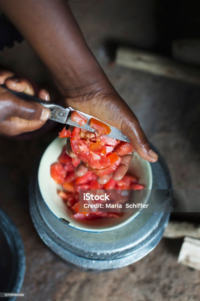 Cooking in Africa Slicing tomatoes in Malawi. Africa Stock Photo