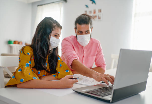 istock dad help  daughter with homework at home 1270930778