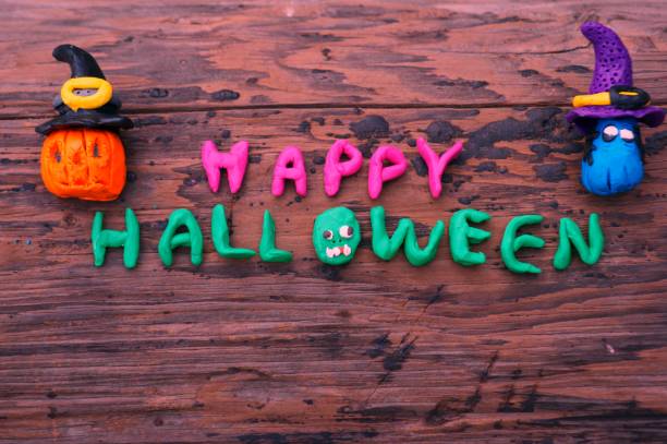 istock Pumpkin and Ghost figurine on a colored background. 1270934283