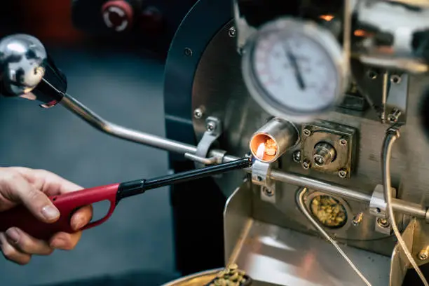close up of coffee roaster process lighting flame