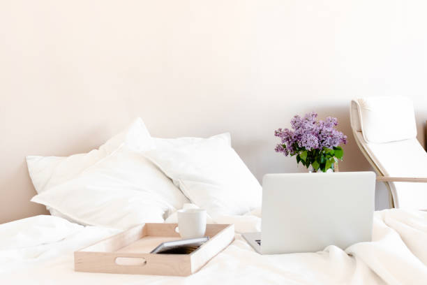 istock Bright room with laptop, mug and notepad on a wooden stand. 1270936823