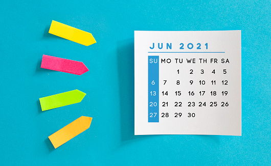 June 2021 calendar on a blue background. Horizontal composition with copy space.