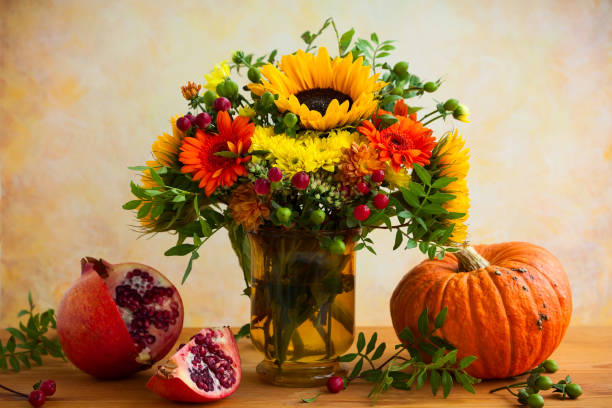 istock Autumn still life with flowers and pumpkin 1270937583
