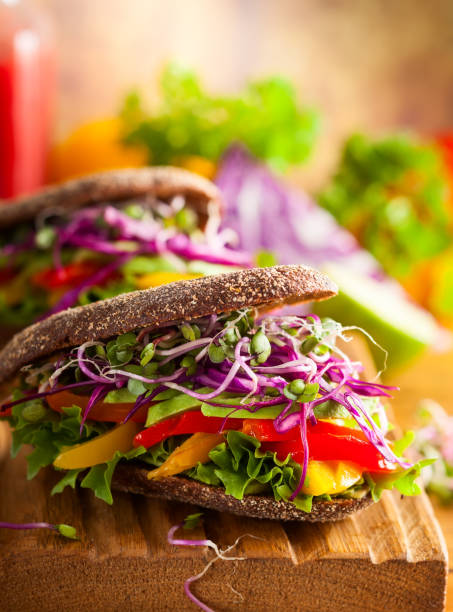 istock Vegan burger or sandwiches with rye bread, different vegetables and sprouts. 1270939434