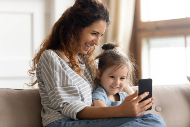 istock Mother her little daughter enjoy distant talk by videoconference app 1270939884