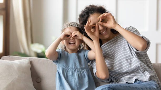 istock Mother and daughter having fun make with fingers eyewear shape 1270939890
