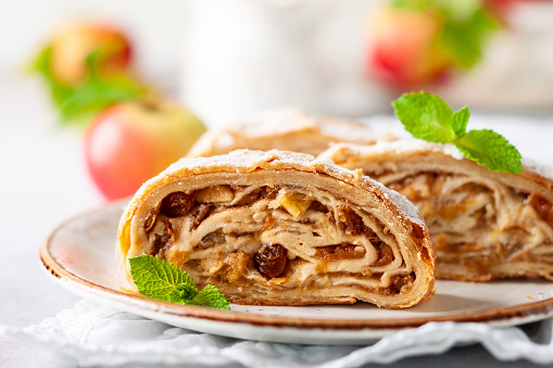 Traditional pieces of apple strudel with cinnamon,raisin, powdered sugar and mint.