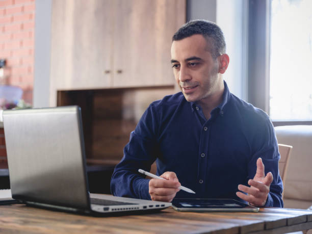 istock Man Is Working Online In Home Office Using His Digital Tablet 1270941387