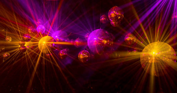 istock mirror balls with glowing purple and gold rays 1270941401