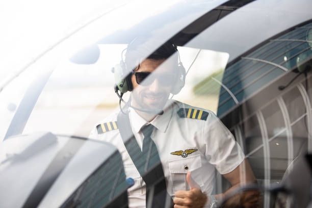 istock Portrait Of Pilot Gesturing While Sitting At Cockpit 1270942266
