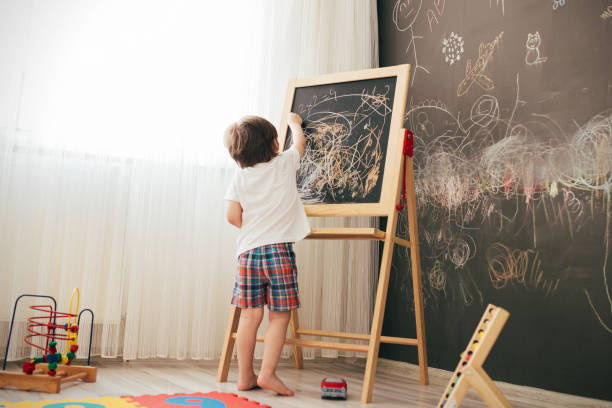 istock Toddler boy drawing on the chalk board 1270942566