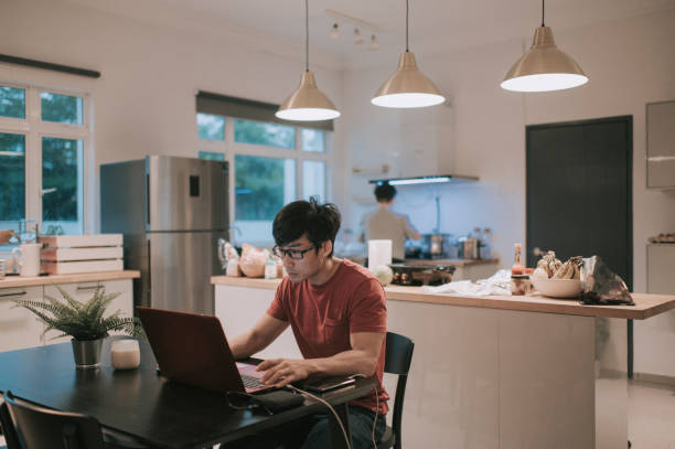 istock asian chinese family in the kitchen preparing breakfast and working using laptop 1270944242