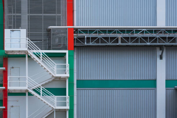 istock Fire escape with conveyor pipeline on factory office building wall 1270945883