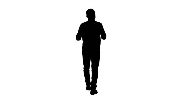 istock Silhouette Handsome hispanic man model talking to the camera and walking 1270946281