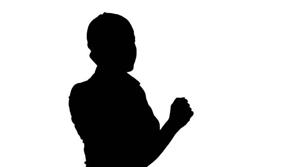Silhouette Charming business woman calling with cell telephone while standing