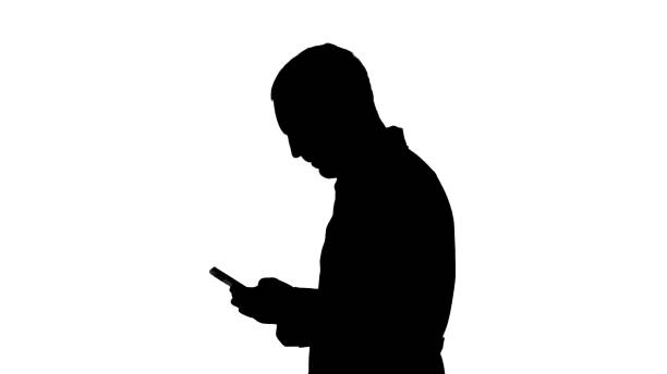 istock Silhouette Walking doctor or nurse texting on a cell phone 1270946414