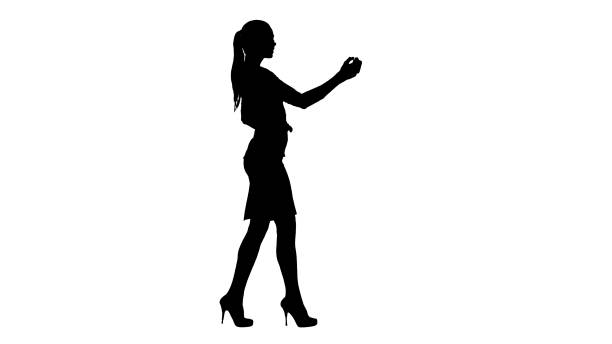 istock Silhouette Pretty girl taking a selfie and walking 1270946431