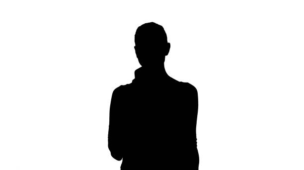 istock Silhouette Beautiful young woman using a mobile phone texting 1270946439