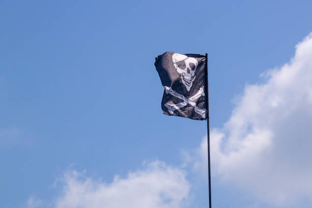 istock pirate flag develops in the wind, skull with bones, Jolly Roger 1270947951