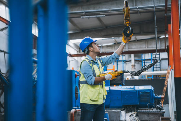 istock Young businessman holding and working with remote control for operating crane 1270948524