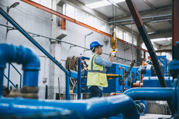 istock Young businessman holding and working with remote control for operating crane 1270948865