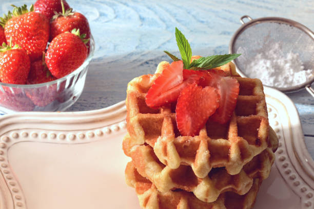 istock closeup Belgian waffles with strawberries 1270949683