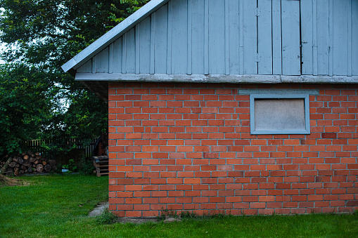 Garage or barn made of red bricks in the backyard.