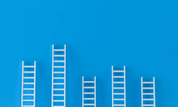 istock Ladder white random collection with one overhanging on blue wall studio background. leadership, success concept. 3d rendering. 1270955617