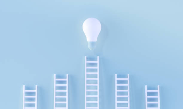 istock Stairs reaching a light bulb in a minimalist blue background. 3D rendering. 1270955629