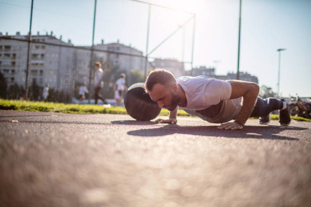 istock Athletic man doing push-up on basketball field 1270957015