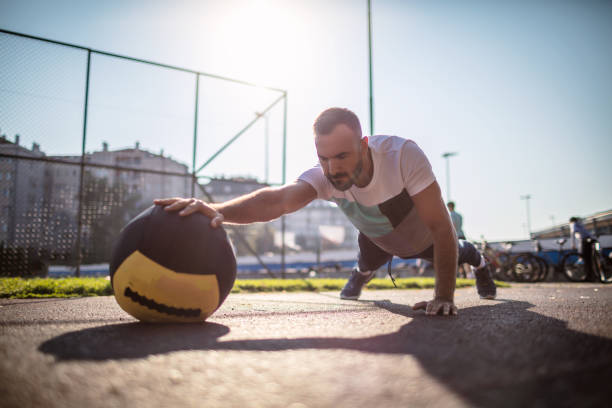 istock Athletic man doing push-up with a medicine ball 1270957225