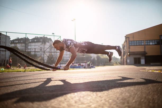 istock Male Athlete Using Battle Ropes Outdoors 1270957837