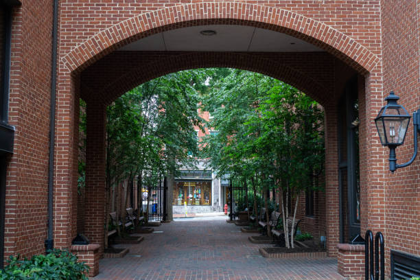 istock brick building with arched entrance. Trees and benches to sit and rest 1270959297
