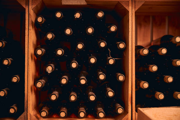 istock Wine bottles with corks stored in wooden racks 1270961665