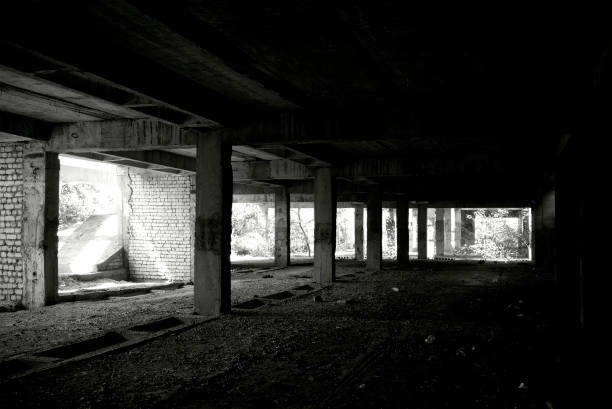 istock Unfinished and abandoned concrete and brick building. Unfinished construction with harsh sun light and shades. 1270962766