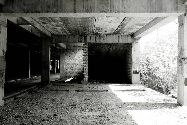 istock Unfinished and abandoned concrete and brick building. Unfinished construction with harsh sun light and shades. 1270962768