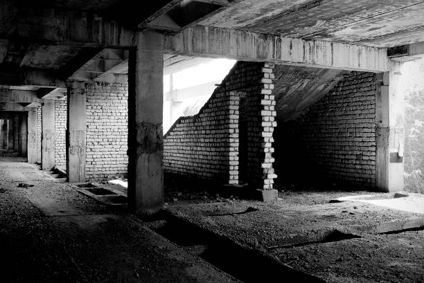 istock Unfinished and abandoned concrete and brick building. Unfinished construction with harsh sun light and shades. 1270962781